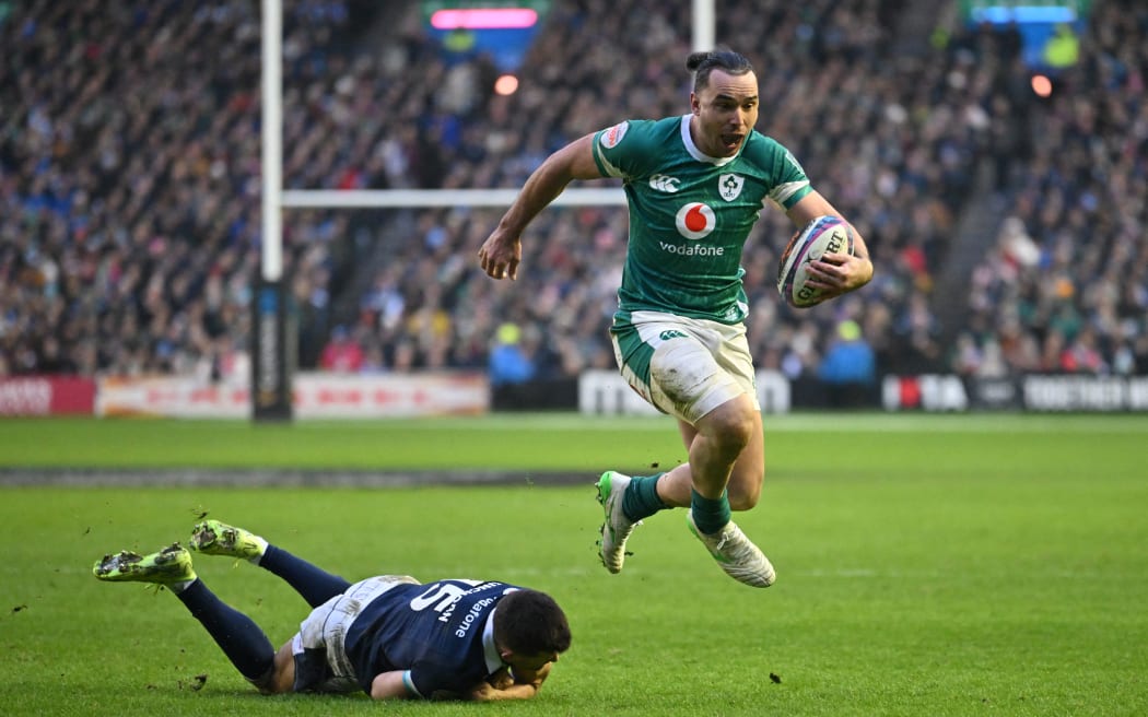 Ireland's wing James Lowe skips away from Scotland's fullback Blair Kinghorn on his way to scoring a try during the Six Nations international at Murrayfield Stadium in Edinburgh, 9 Feb, 2025.