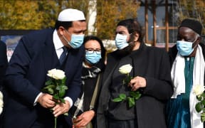 Imam of Drancy Hassen Chalghoumi (L) and French Jewish writer Marek Halter (2nd R) attend a gathering of imams outside the Bois d'Aulne secondary school