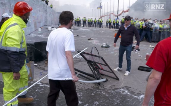 One man pleads with protesters to stop the destruction during the riots at the end occupation of Parliament on 2 March 2022.