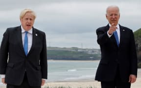 Britain's Prime Minister Boris Johnson (L) welcomes US President Joe Biden during the G7 summit in Carbis Bay, Cornwall, south-west England on June 11, 2021.