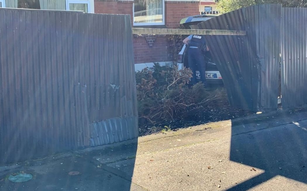 Police car crashed through a fence into a Herbert Street residents front lawn.