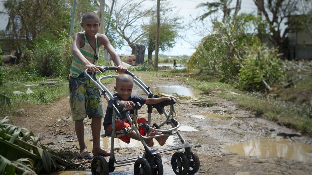 Children on muddy roads at Lovu.