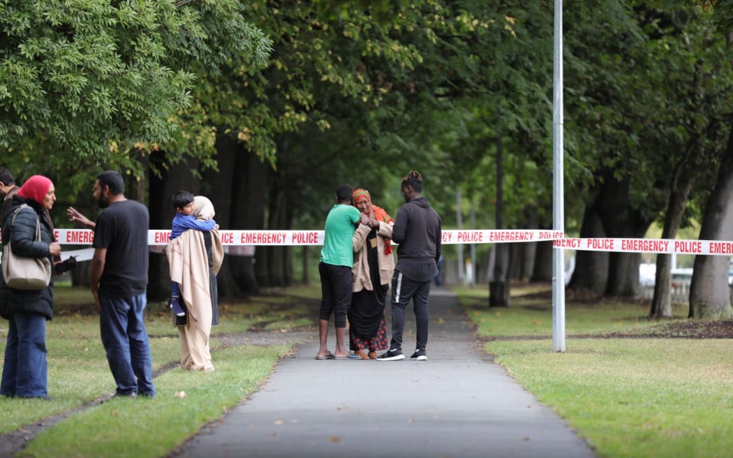 Police taping off the street out Christchurch mosque, families reunite