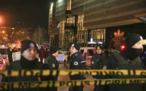 Turkish police in front of the building where the Russian Ambassador to Turkey was shot.