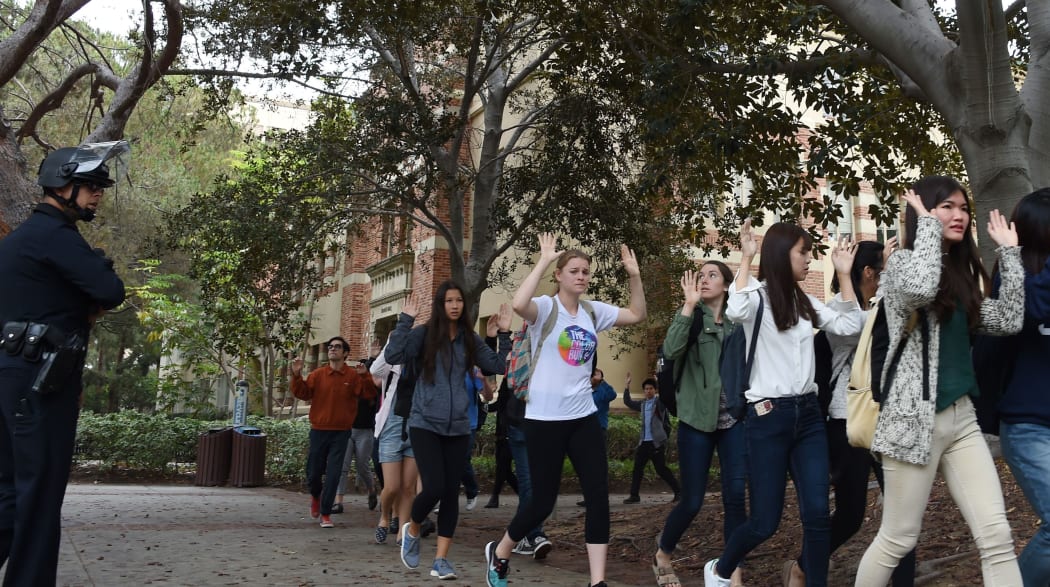 Students Raise their hands as they are led away by police after the shooting at a UCLA campus.