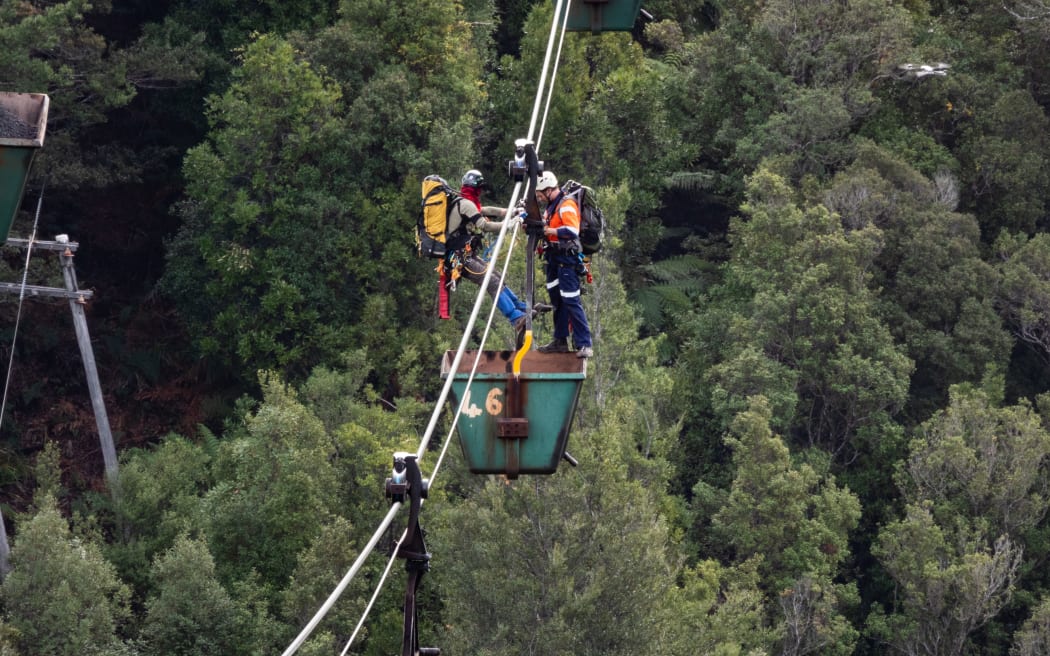 Two Climate Liberation Aotearoa protesters used the aerial rope way down to Ngakawau to access a coal bucket for a sit-in protest.